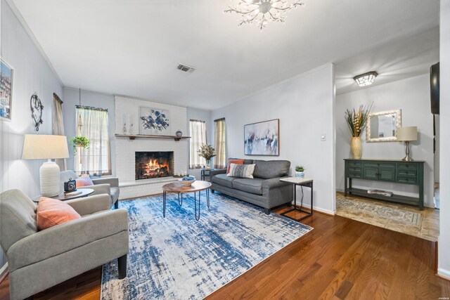 206 Shawnee St, Hot Springs, AR 71901 - living area with dark wood-style floors, a brick fireplace, plenty of natural light, and a chandelier