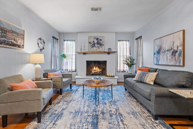 206 Shawnee St, Hot Springs, AR 71901 - living area featuring plenty of natural light, wood finished floors, ornamental molding, and a brick fireplace