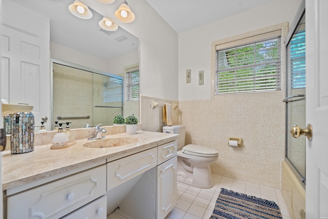 206 Shawnee St, Hot Springs, AR 71901 - bathroom with tile patterned flooring, toilet, tile walls, vanity, and a wainscoted wall