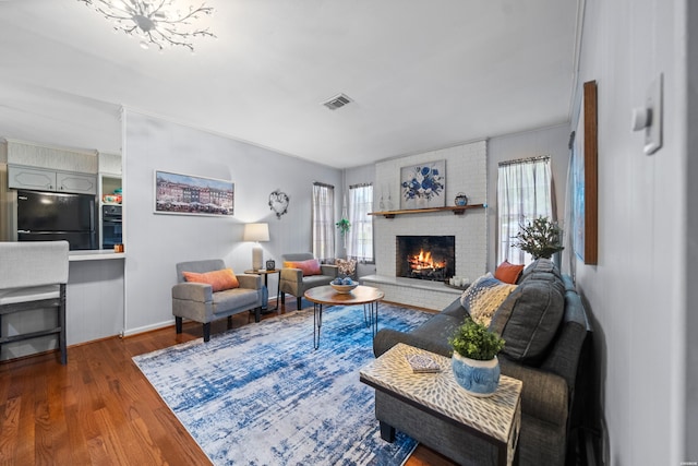 206 Shawnee St, Hot Springs, AR 71901 - living room with a brick fireplace, wood finished floors, and baseboards