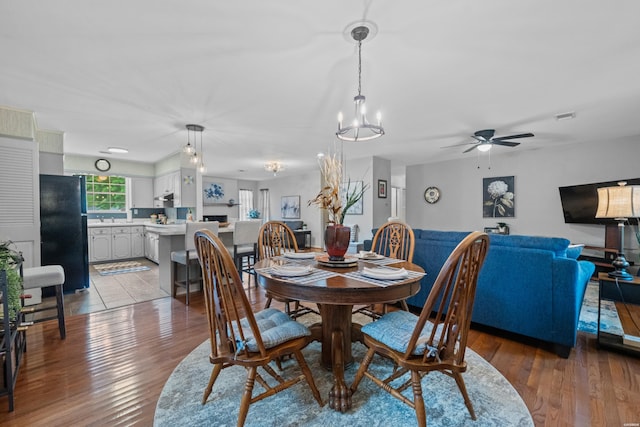206 Shawnee St, Hot Springs, AR 71901 - dining area with a chandelier, wood finished floors, and a ceiling fan