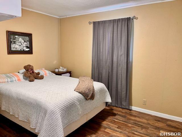 906 Surrey Rd, Hot Springs, AR 71909 - bedroom with crown molding, baseboards, and wood finished floors