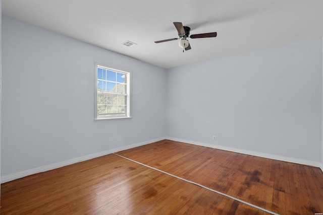 1526 Pearcy Rd, Pearcy, AR 71964 - empty room with wood finished floors, ceiling fan, and baseboards