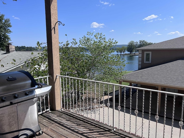 balcony with a water view and area for grilling