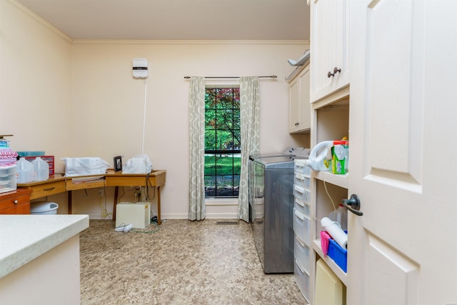 clothes washing area featuring crown molding, baseboards, cabinet space, and washer and dryer