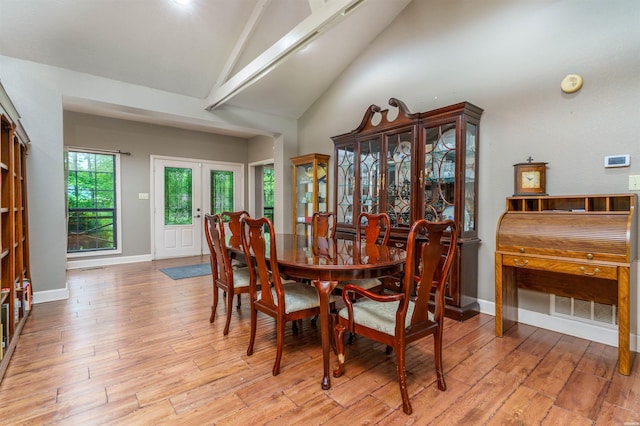 dining area featuring visible vents, beamed ceiling, high vaulted ceiling, light wood-type flooring, and french doors
