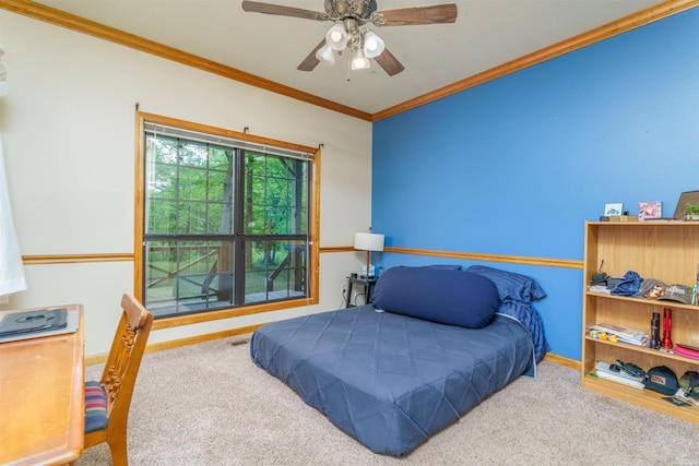 bedroom featuring crown molding, baseboards, ceiling fan, and carpet flooring