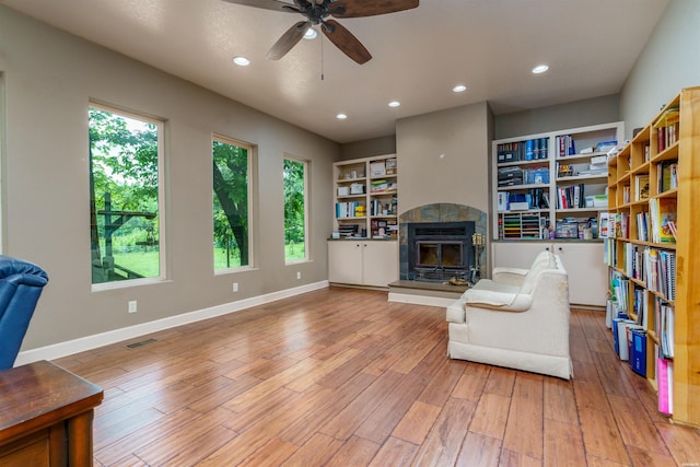 sitting room featuring visible vents, ceiling fan, recessed lighting, a tiled fireplace, and light wood finished floors