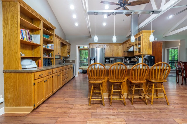 dining room with ceiling fan, high vaulted ceiling, recessed lighting, light wood-type flooring, and beamed ceiling