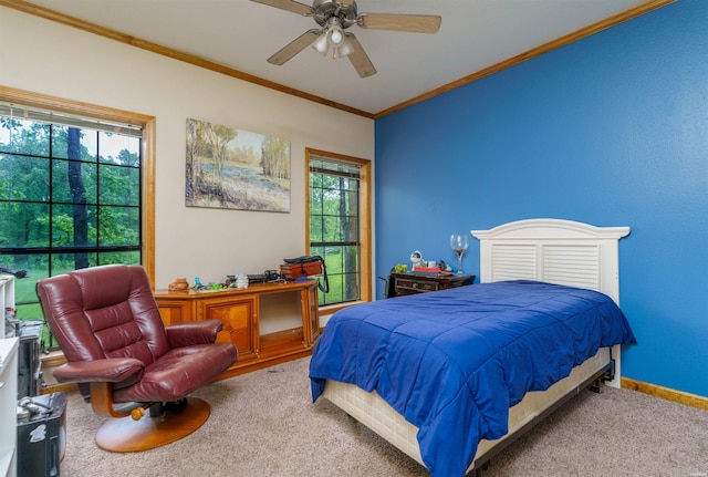 carpeted bedroom featuring crown molding, baseboards, ceiling fan, and multiple windows