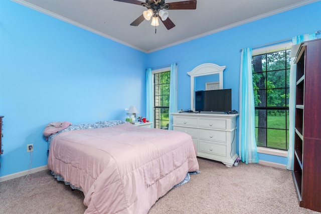 bedroom with carpet floors, ornamental molding, baseboards, and ceiling fan
