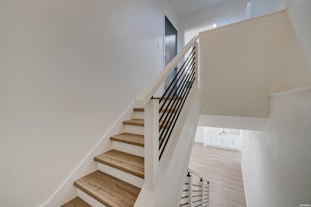 stairway with wood finished floors