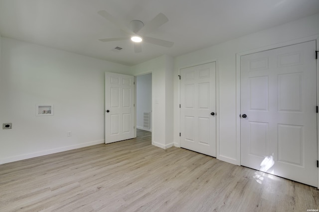 unfurnished bedroom with a ceiling fan, light wood-type flooring, visible vents, and baseboards