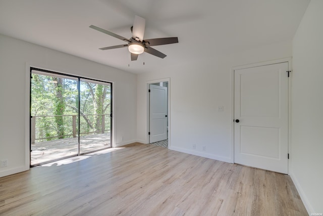 empty room with light wood-style floors, ceiling fan, and baseboards