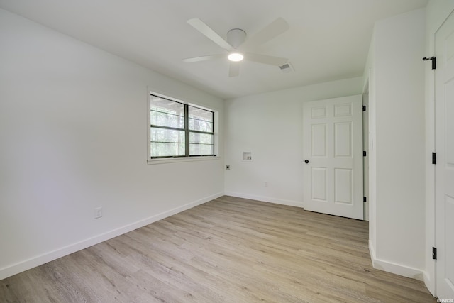 empty room with baseboards, ceiling fan, and light wood finished floors