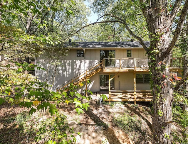 back of house with a deck and stairs