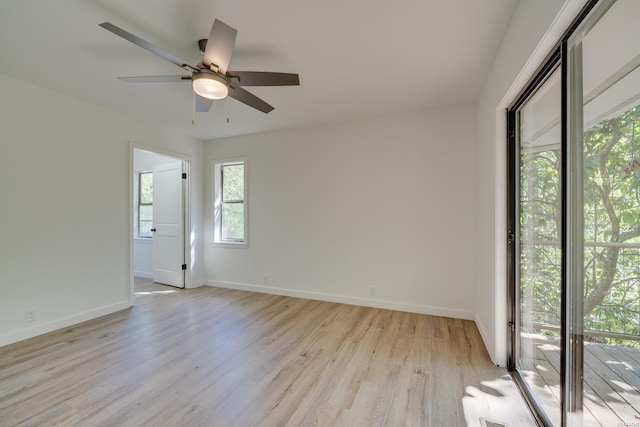 empty room with ceiling fan, light wood-style flooring, and baseboards