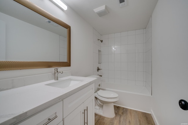 full bath featuring shower / bath combination, visible vents, toilet, vanity, and wood finished floors