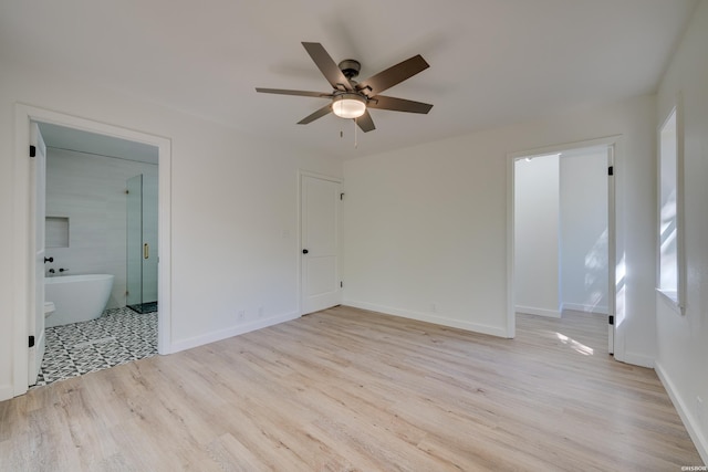 unfurnished room featuring light wood finished floors, baseboards, and a ceiling fan