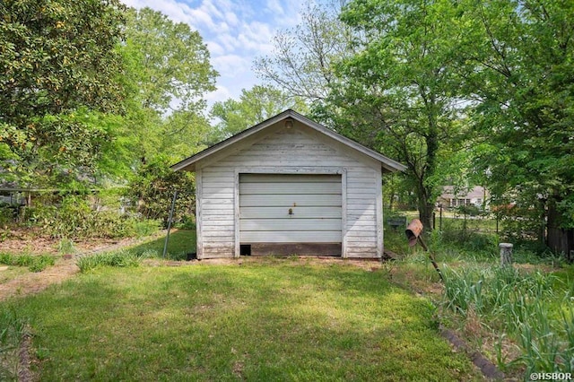detached garage featuring fence
