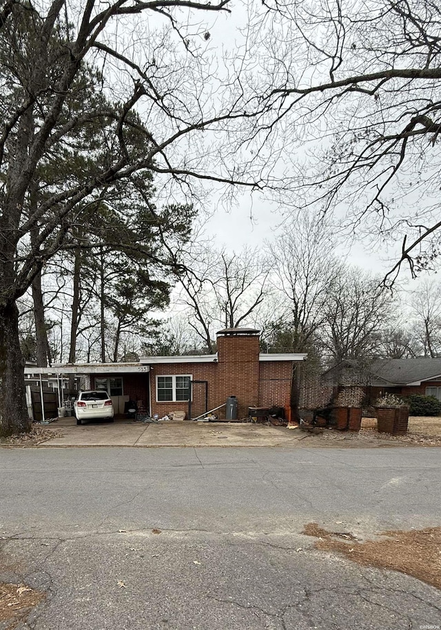 view of front of property with a carport and brick siding