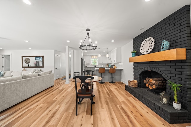 624 Ridgeway St, Hot Springs, AR 71901 - living area with recessed lighting, a chandelier, light wood-type flooring, and a brick fireplace