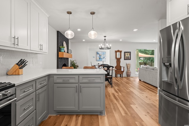 624 Ridgeway St, Hot Springs, AR 71901 - kitchen with stainless steel fridge with ice dispenser, range, gray cabinets, a peninsula, and light countertops