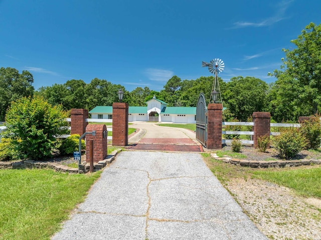view of gate with a fenced front yard