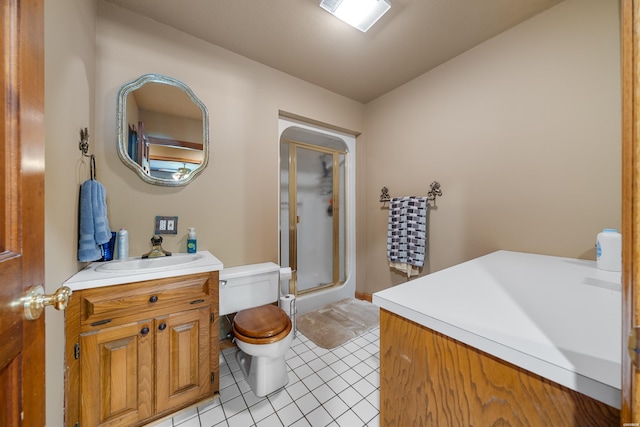 bathroom featuring visible vents, toilet, vanity, a shower stall, and tile patterned flooring