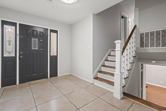 75 Grant 7, Sheridan, AR 72150 - foyer featuring light tile patterned floors, stairs, visible vents, and baseboards