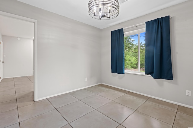 75 Grant 7, Sheridan, AR 72150 - spare room featuring an inviting chandelier, tile patterned floors, and baseboards