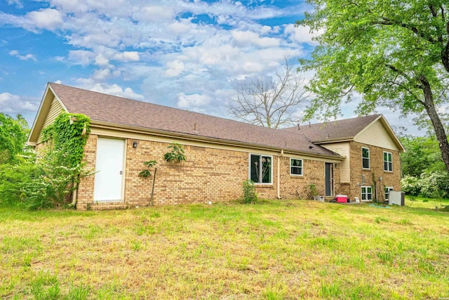 75 Grant 7, Sheridan, AR 72150 - rear view of property with a lawn, a shingled roof, and brick siding