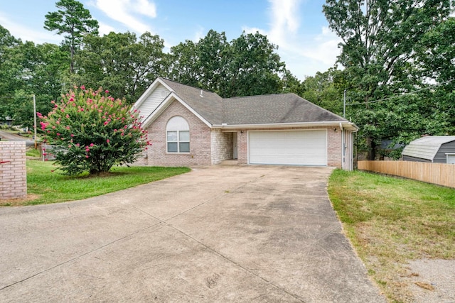 ranch-style home with an attached garage, a front lawn, concrete driveway, and brick siding