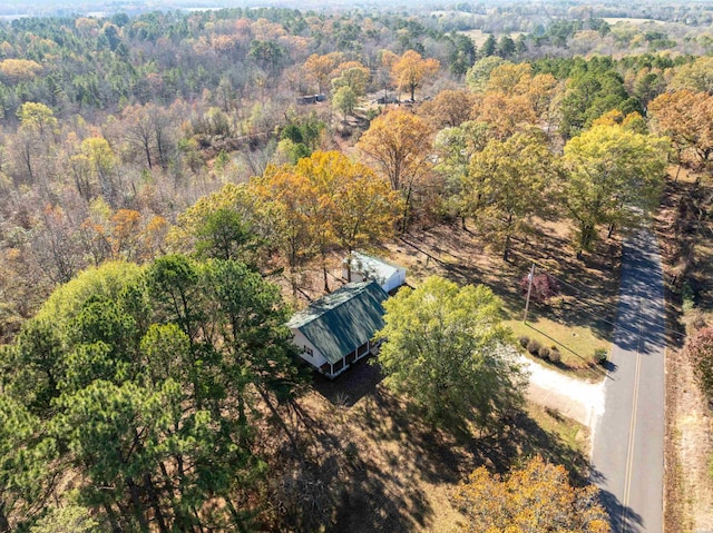 birds eye view of property featuring a view of trees