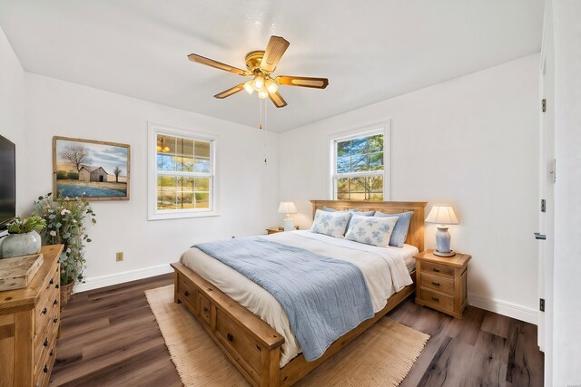 bedroom with dark wood-style floors, baseboards, and a ceiling fan