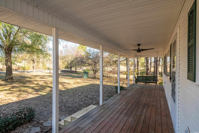 wooden deck with a ceiling fan