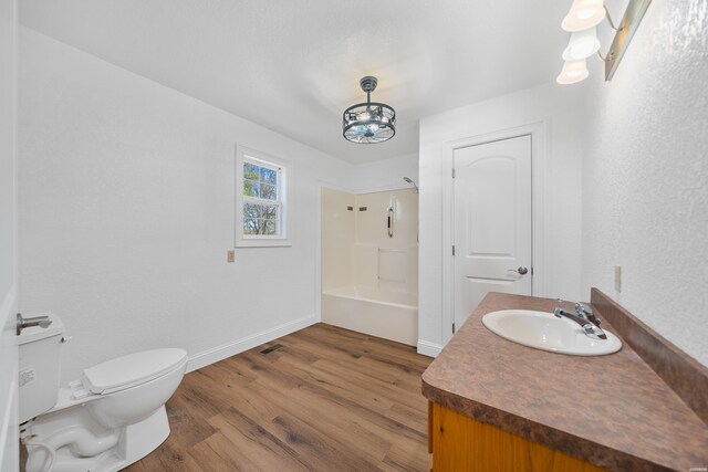 full bathroom featuring baseboards, toilet, wood finished floors, bathtub / shower combination, and vanity