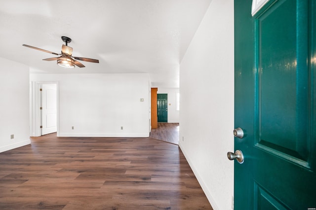 entrance foyer with dark wood-style floors, ceiling fan, and baseboards