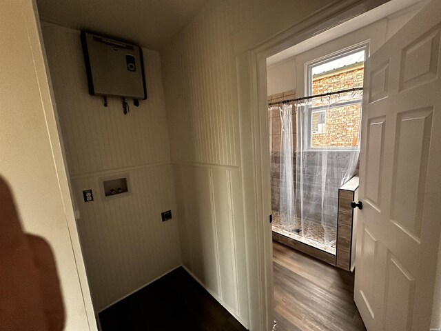 clothes washing area with hookup for a washing machine, hookup for an electric dryer, a wainscoted wall, laundry area, and dark wood-style flooring