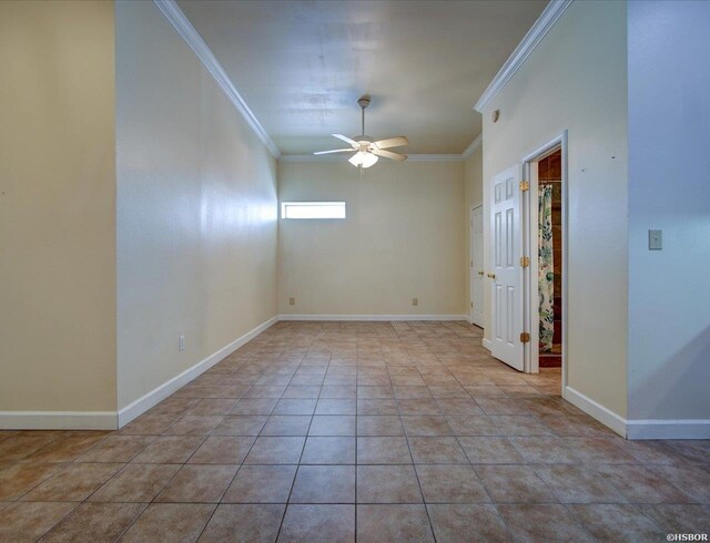 spare room featuring light tile patterned floors, ornamental molding, a ceiling fan, and baseboards