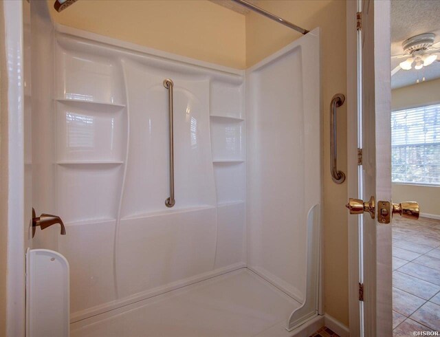 full bathroom with tile patterned flooring and walk in shower