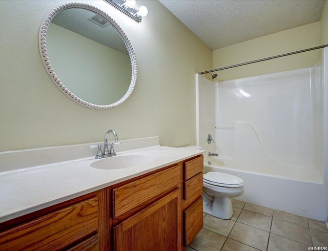 bathroom featuring bathtub / shower combination, toilet, a textured ceiling, vanity, and tile patterned floors