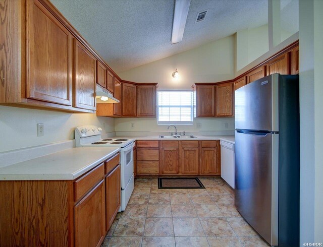 kitchen with brown cabinets, white appliances, light countertops, and under cabinet range hood