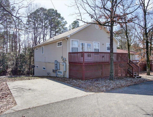 rear view of property with a wooden deck