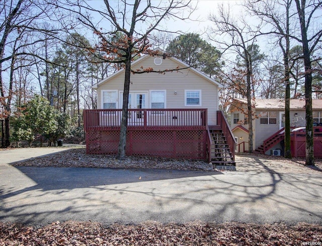 view of front of home with stairs and a deck