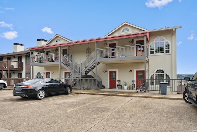 townhome / multi-family property featuring stairway and stucco siding