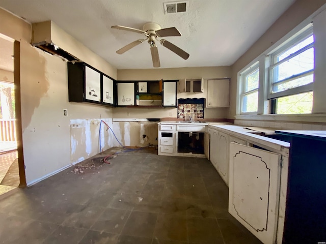 kitchen with light countertops, visible vents, and white cabinetry