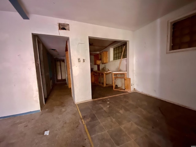 empty room with beamed ceiling