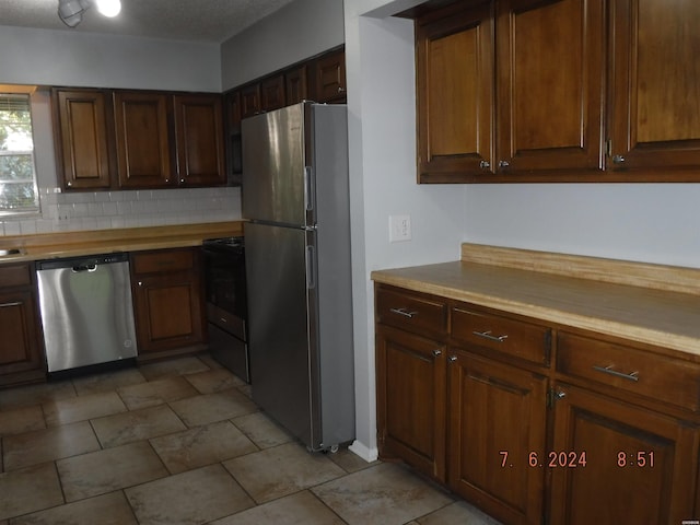 kitchen featuring stainless steel appliances and backsplash