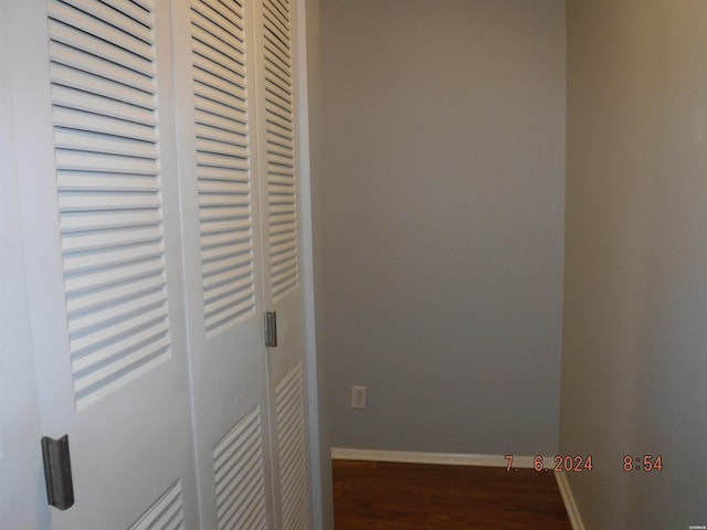 interior space featuring baseboards and wood finished floors